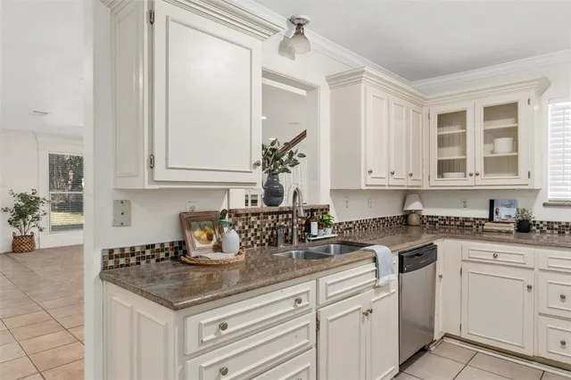 a kitchen with stainless steel appliances granite countertop a sink and cabinets