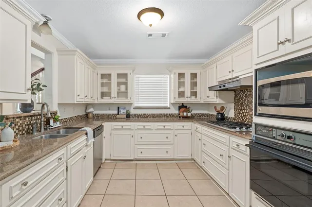 a kitchen with a sink stove and cabinets
