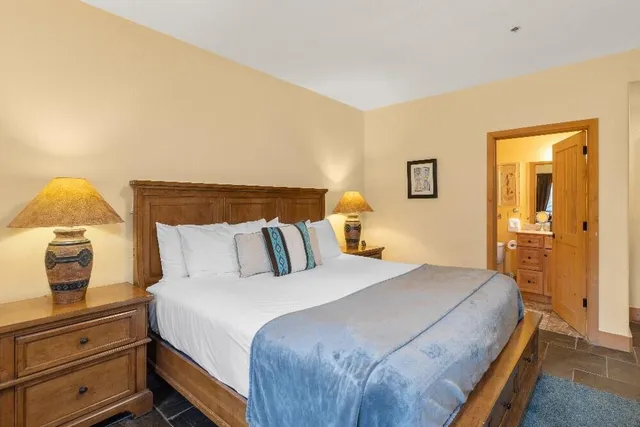 a bedroom with a bed and lamp