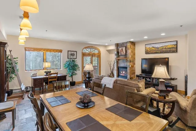 a living room with furniture a rug and a large window
