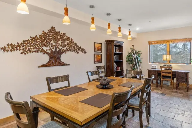 a view of a dining room with furniture and window