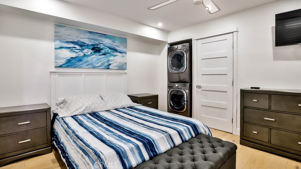 218 16th Street, Unit B Huntington Beach, CA 92648 - Photo 11 of 14 a bedroom with a bed and a tv