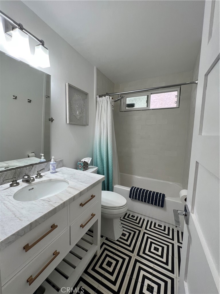 218 16th Street, Unit B Huntington Beach, CA 92648 - Photo 13 of 14 a bathroom with a double vanity sink and mirror