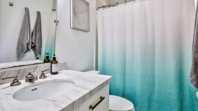 a bathroom with a sink toilet and mirror