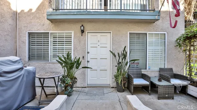 a view of a house with a potted plant and sitting area
