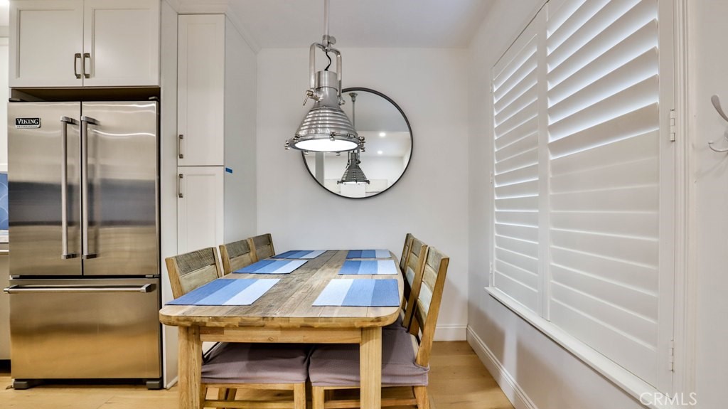 218 16th Street, Unit B Huntington Beach, CA 92648 - Photo 4 of 14 a view of a dining room with furniture and wooden floor