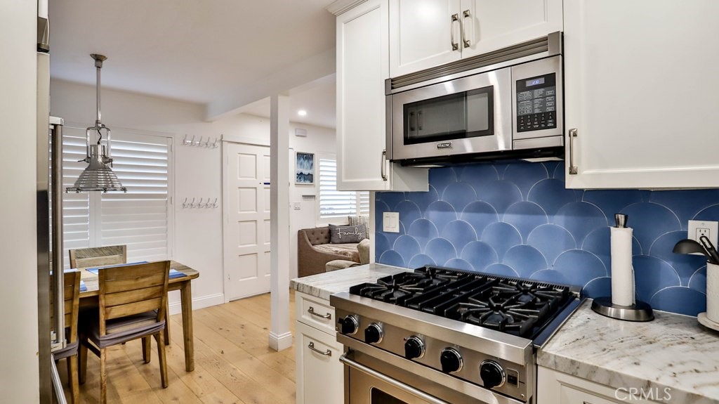218 16th Street, Unit B Huntington Beach, CA 92648 - Photo 7 of 14 a kitchen with a stove and a microwave