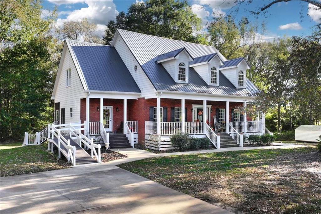 51 Howiington Road Jefferson, GA 30549 - Photo 1 of 81 a front view of a house with garden