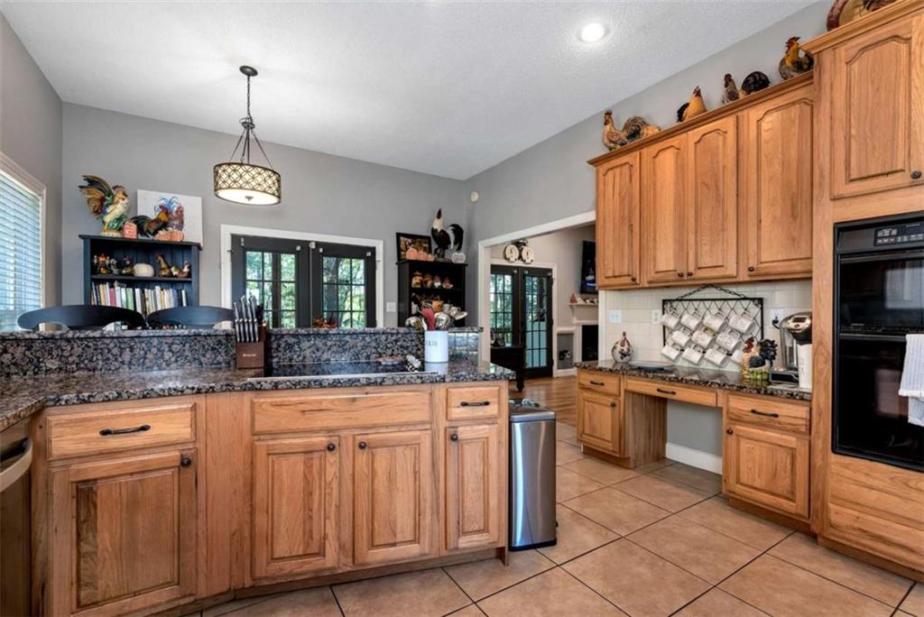51 Howiington Road Jefferson, GA 30549 - Photo 13 of 81 a kitchen with granite countertop a sink and cabinets