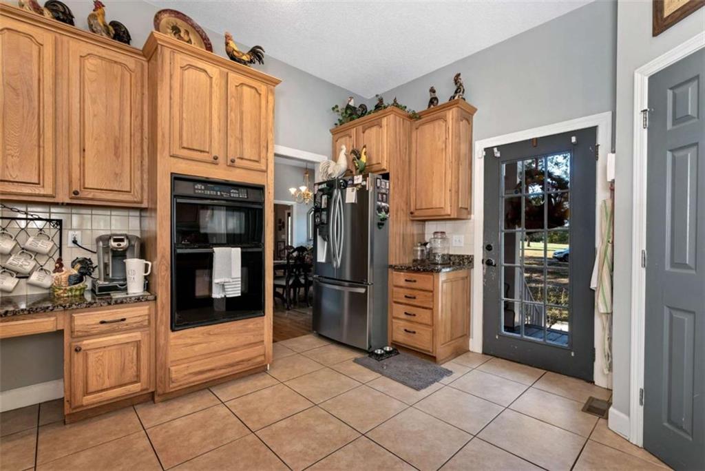 51 Howiington Road Jefferson, GA 30549 - Photo 15 of 81 a kitchen with stainless steel appliances granite countertop a refrigerator and a stove top oven