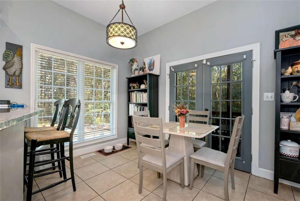 51 Howiington Road Jefferson, GA 30549 - Photo 16 of 81 a dining room with wooden floor a glass table and chairs