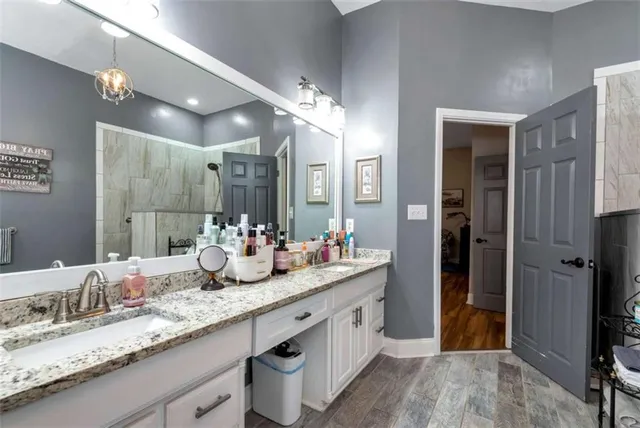a bathroom with a sink a mirror and a shower