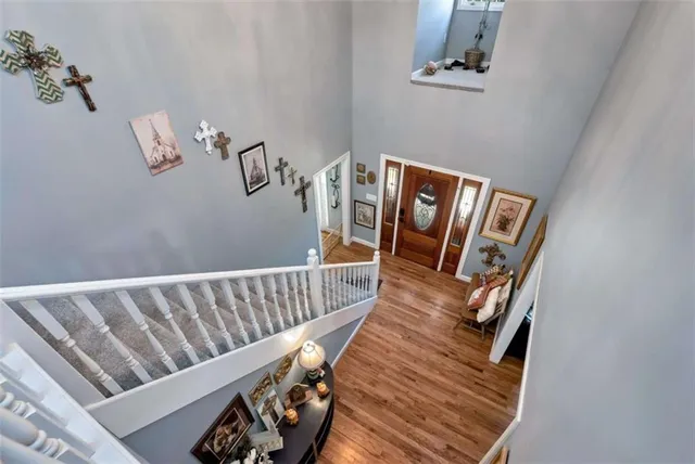 a living room with furniture kitchen view and a wooden floor