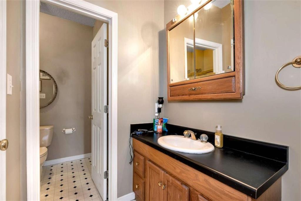 51 Howiington Road Jefferson, GA 30549 - Photo 36 of 81 a bathroom with a sink a mirror and a shower