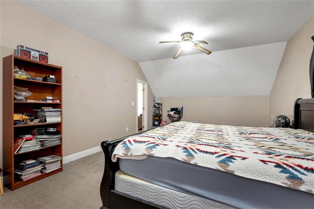 51 Howiington Road Jefferson, GA 30549 - Photo 39 of 81 a bedroom with a bed and a chandelier