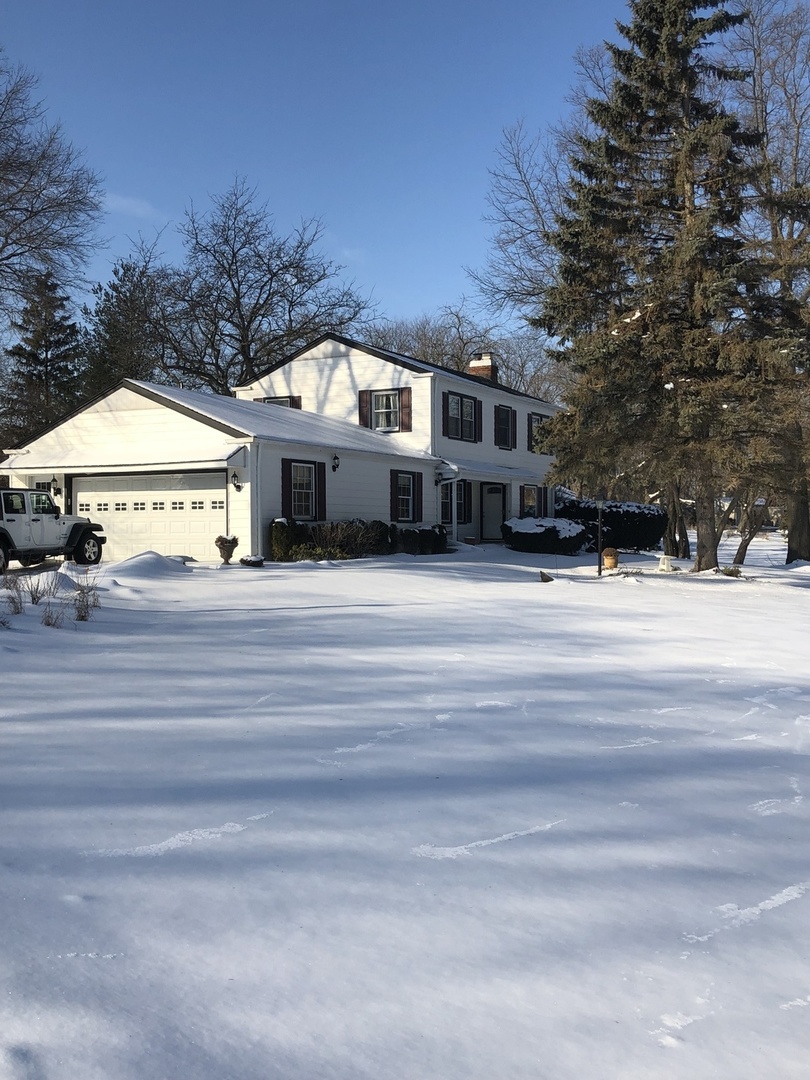 1577 Banbury Road Inverness, IL 60067 - Photo 1 of 8 a front view of a house with a yard