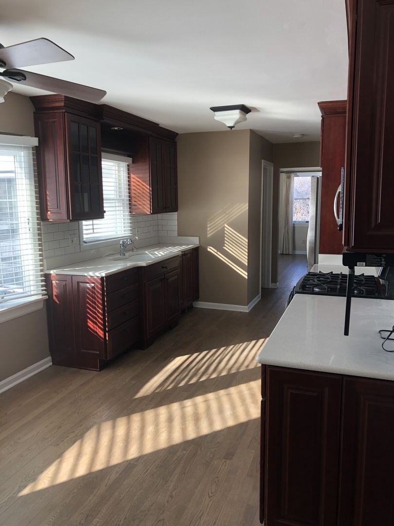 1577 Banbury Road Inverness, IL 60067 - Photo 4 of 8 a kitchen with stainless steel appliances granite countertop a sink and a stove