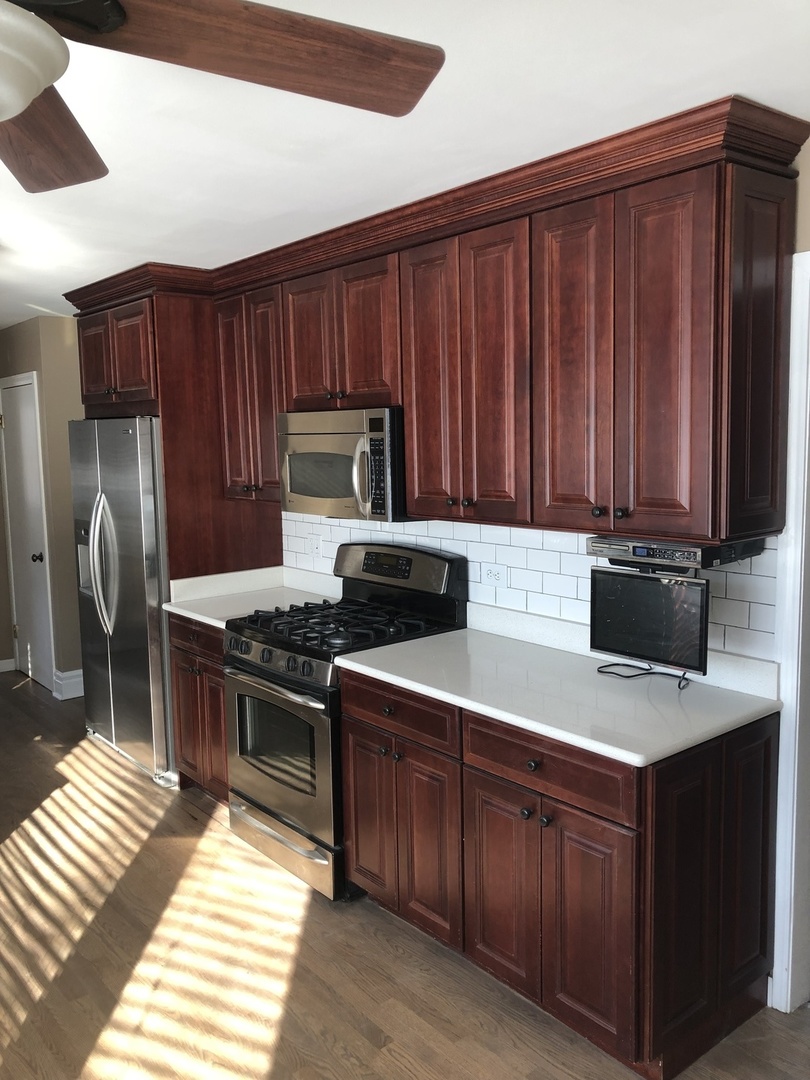 1577 Banbury Road Inverness, IL 60067 - Photo 5 of 8 a kitchen with stainless steel appliances granite countertop wooden cabinets a stove top oven a sink and dishwasher