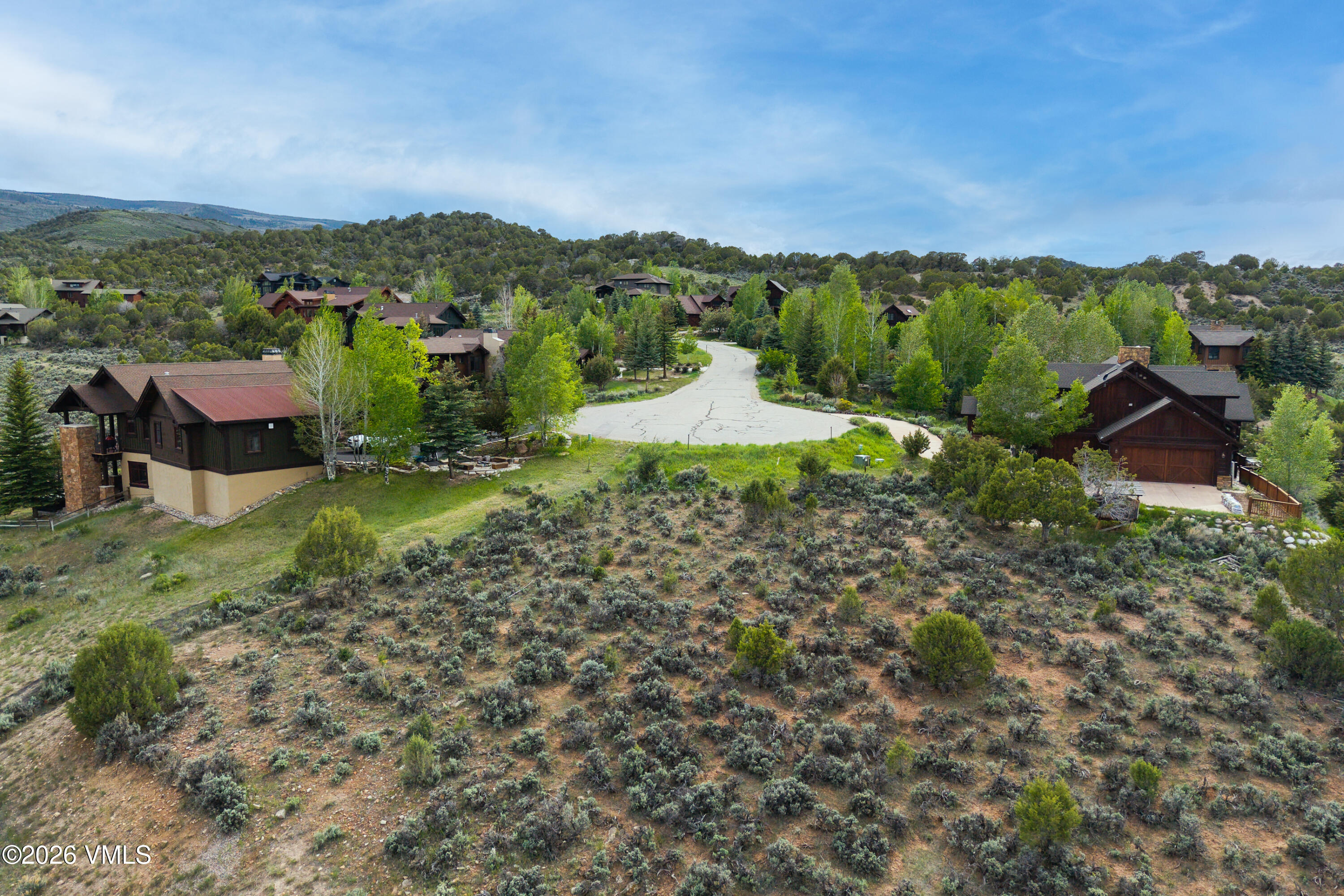 1194 Hernage Creek Road Eagle, CO 81631 - Photo 6 of 8 a view of a lush green hillside and houses