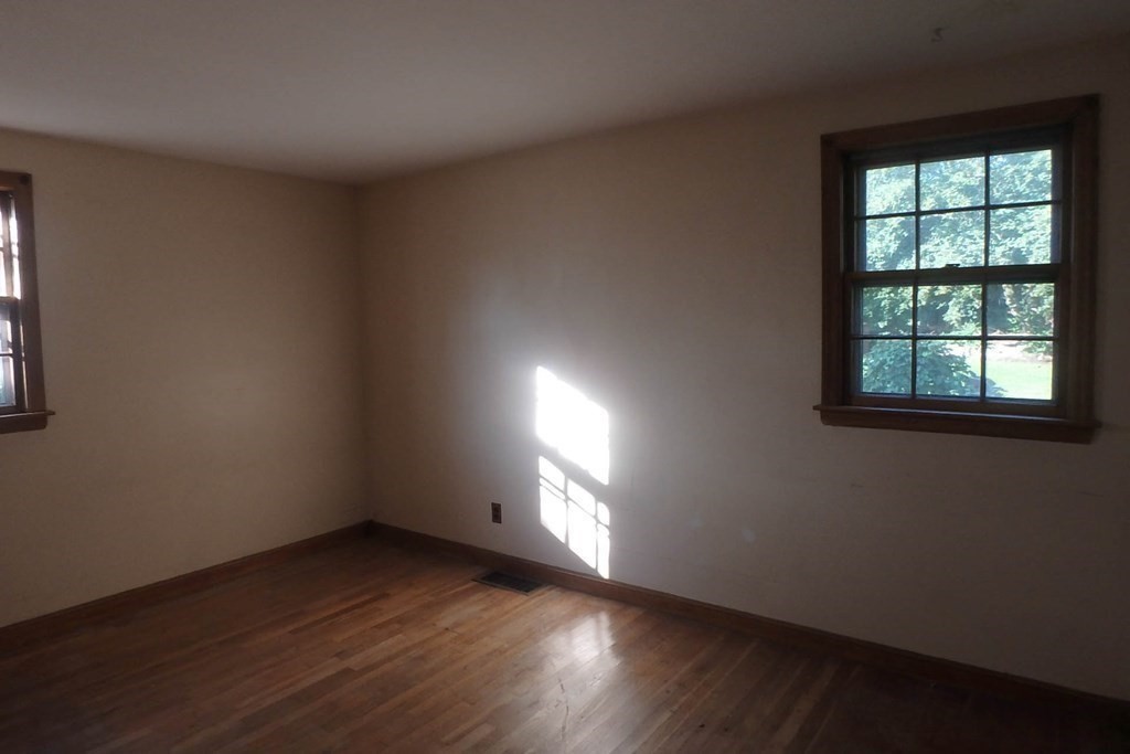 285 Andover Street Danvers, MA 01923 - Photo 11 of 20 an empty room with wooden floor and windows
