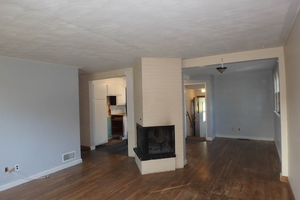 285 Andover Street Danvers, MA 01923 - Photo 16 of 20 an empty room with wooden floor and fireplace