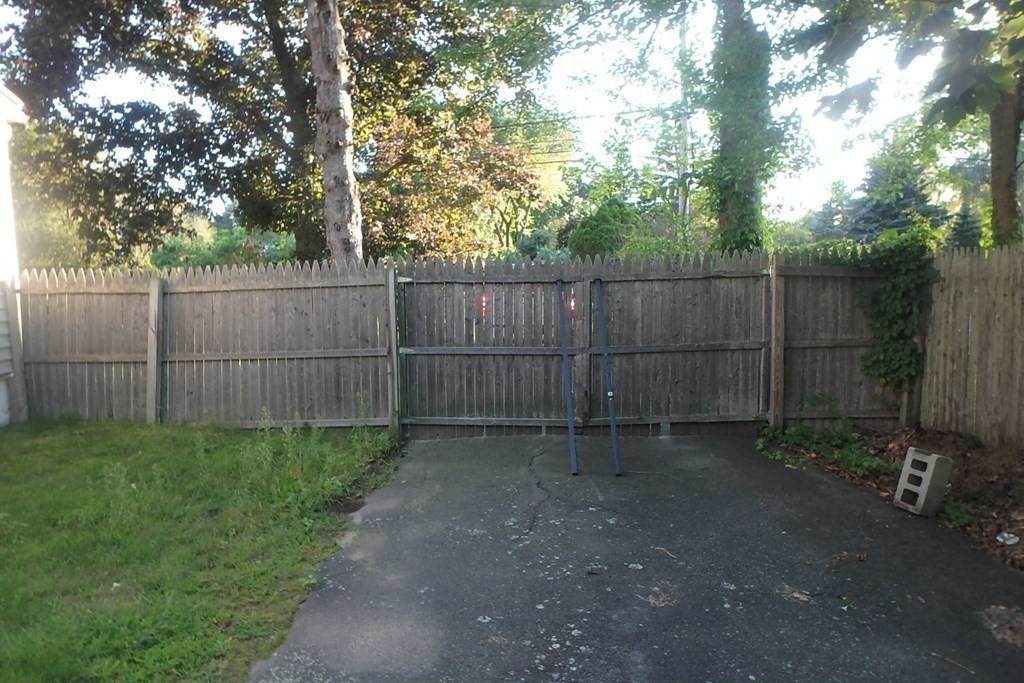 285 Andover Street Danvers, MA 01923 - Photo 3 of 20 a backyard of a house with a small cabin and wooden fence