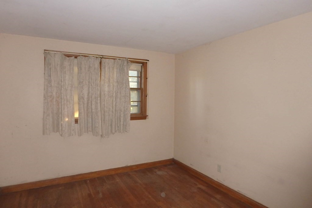 285 Andover Street Danvers, MA 01923 - Photo 6 of 20 a view of an empty room with wooden floor and a window