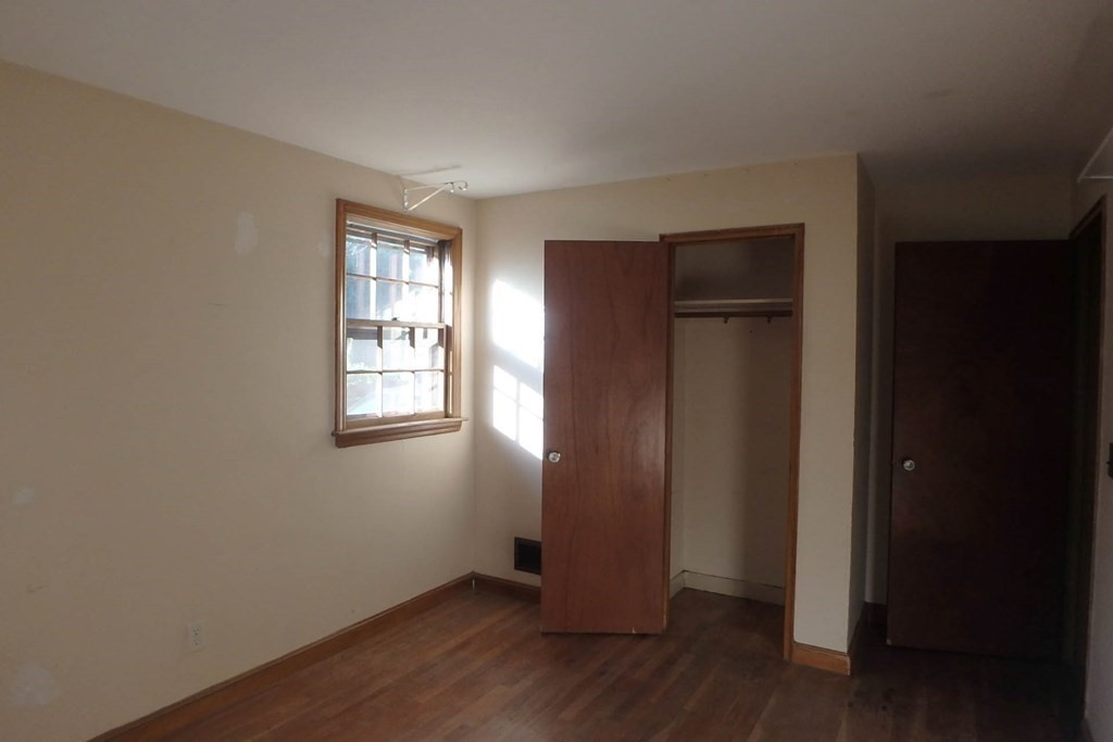 285 Andover Street Danvers, MA 01923 - Photo 9 of 20 an empty room with wooden floor closet and windows