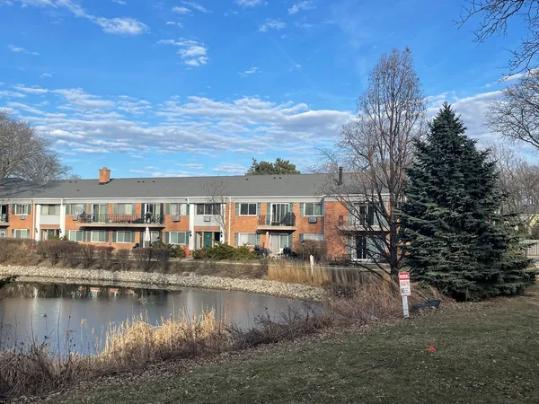 a view of a house with pool and lake view
