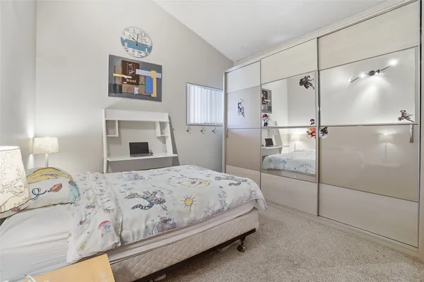 a bedroom with a bed and a walk in closet