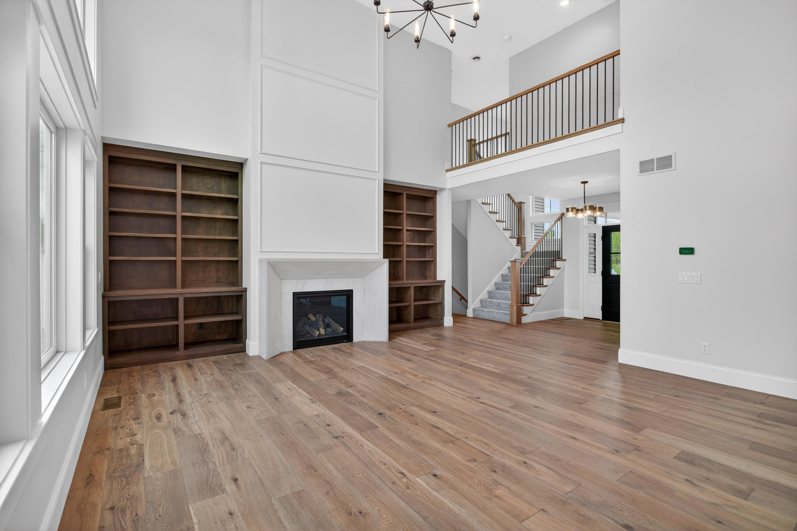6928 Wilderness Pointe Bettendorf, IA 52722 - Photo 12 of 48 wooden floor fireplace and windows in an empty room
