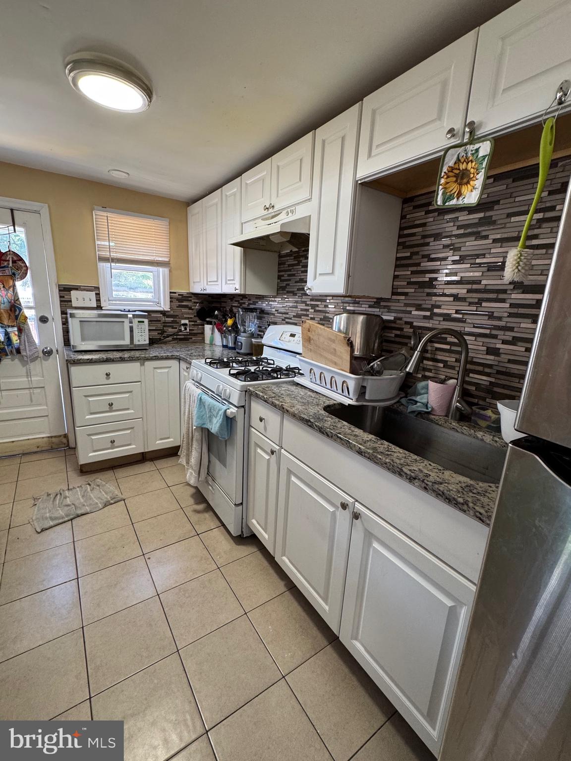 1515 Collings Road Camden, NJ 08104 - Photo 6 of 23 a kitchen with a sink a stove and cabinets