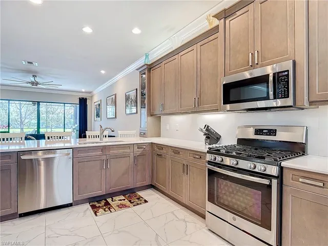 a kitchen with granite countertop cabinets stainless steel appliances and a sink
