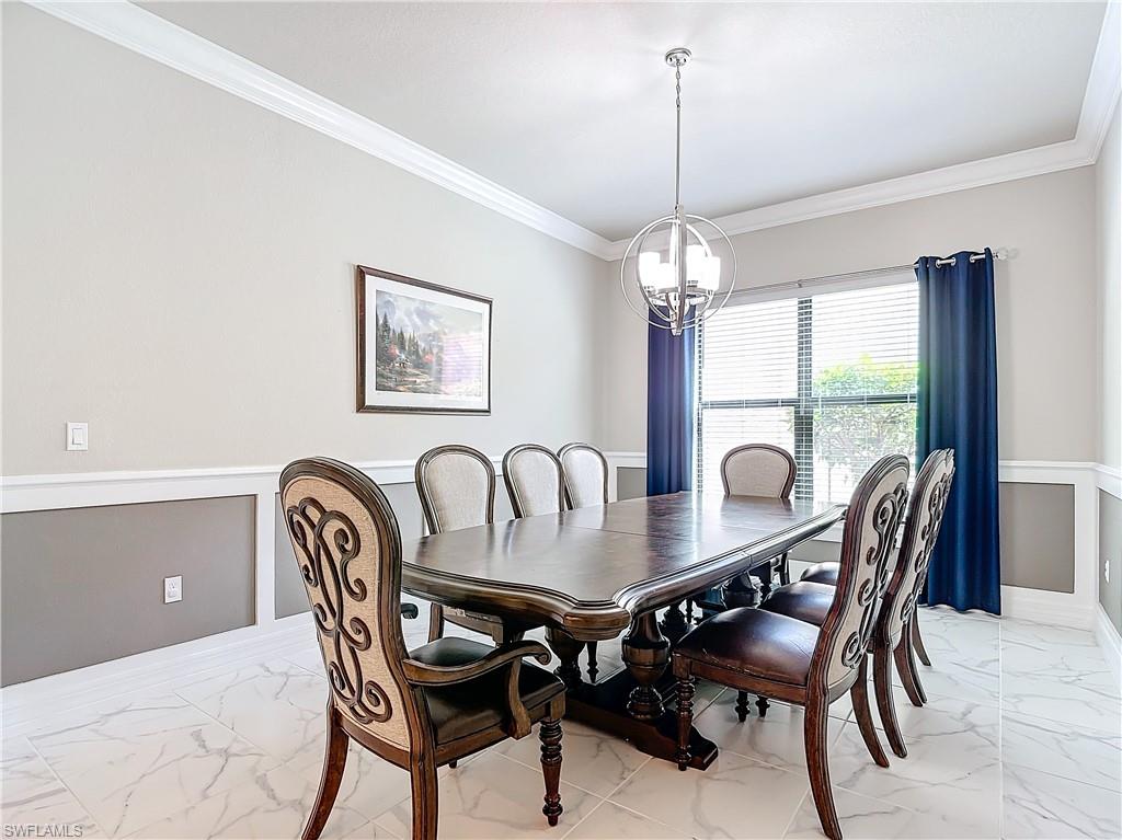 4310 Aurora Street Naples, FL 34119 - Photo 18 of 50 a view of a dining room with furniture window and outside view
