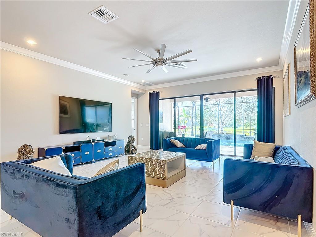 4310 Aurora Street Naples, FL 34119 - Photo 20 of 50 a living room with furniture and a flat screen tv