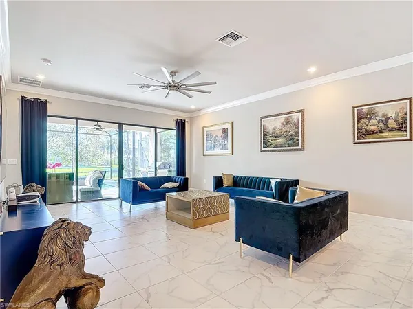 a living room with furniture and large windows