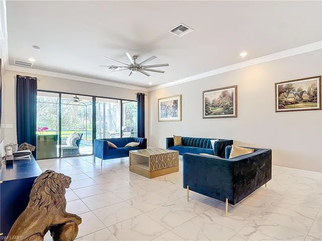 a living room with furniture and large windows