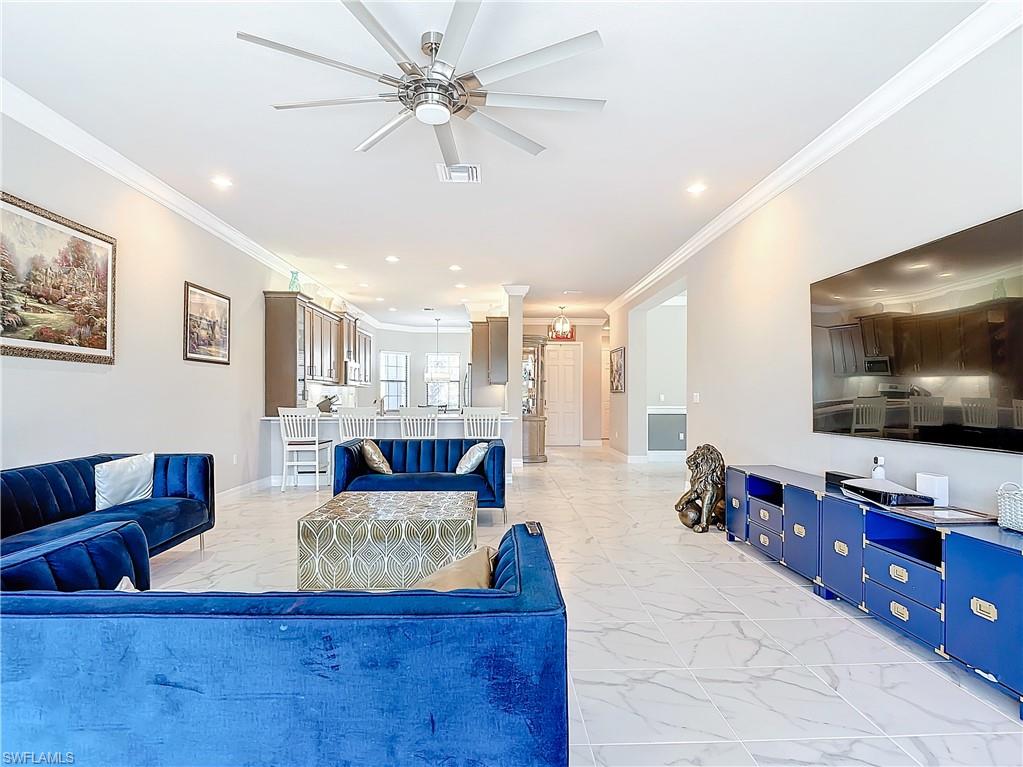 4310 Aurora Street Naples, FL 34119 - Photo 25 of 50 a living room with furniture and a flat screen tv