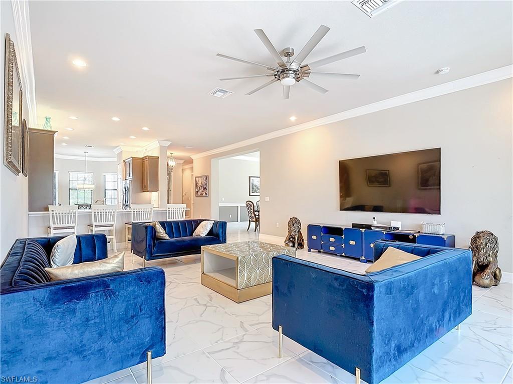 4310 Aurora Street Naples, FL 34119 - Photo 26 of 50 a living room with furniture and a flat screen tv