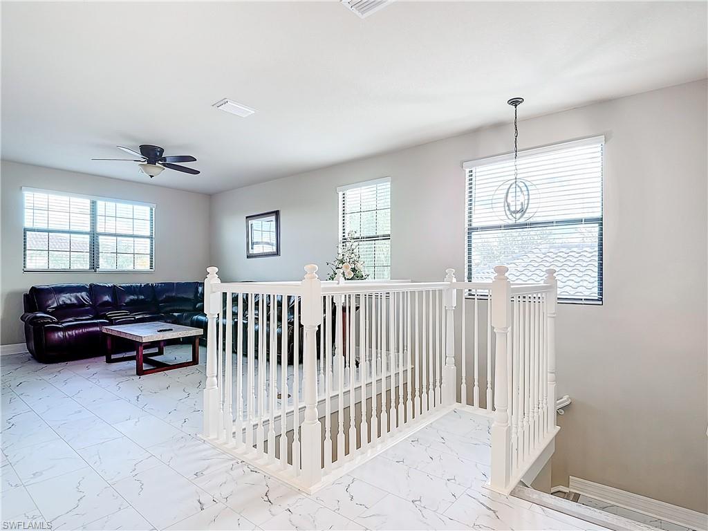 4310 Aurora Street Naples, FL 34119 - Photo 27 of 50 a bedroom with furniture and a window