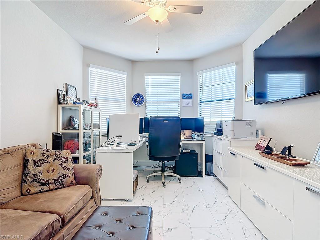 4310 Aurora Street Naples, FL 34119 - Photo 30 of 50 a living room with furniture and a flat screen tv
