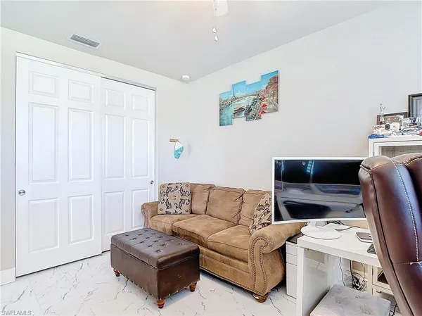 a living room with furniture a couch and a view of kitchen