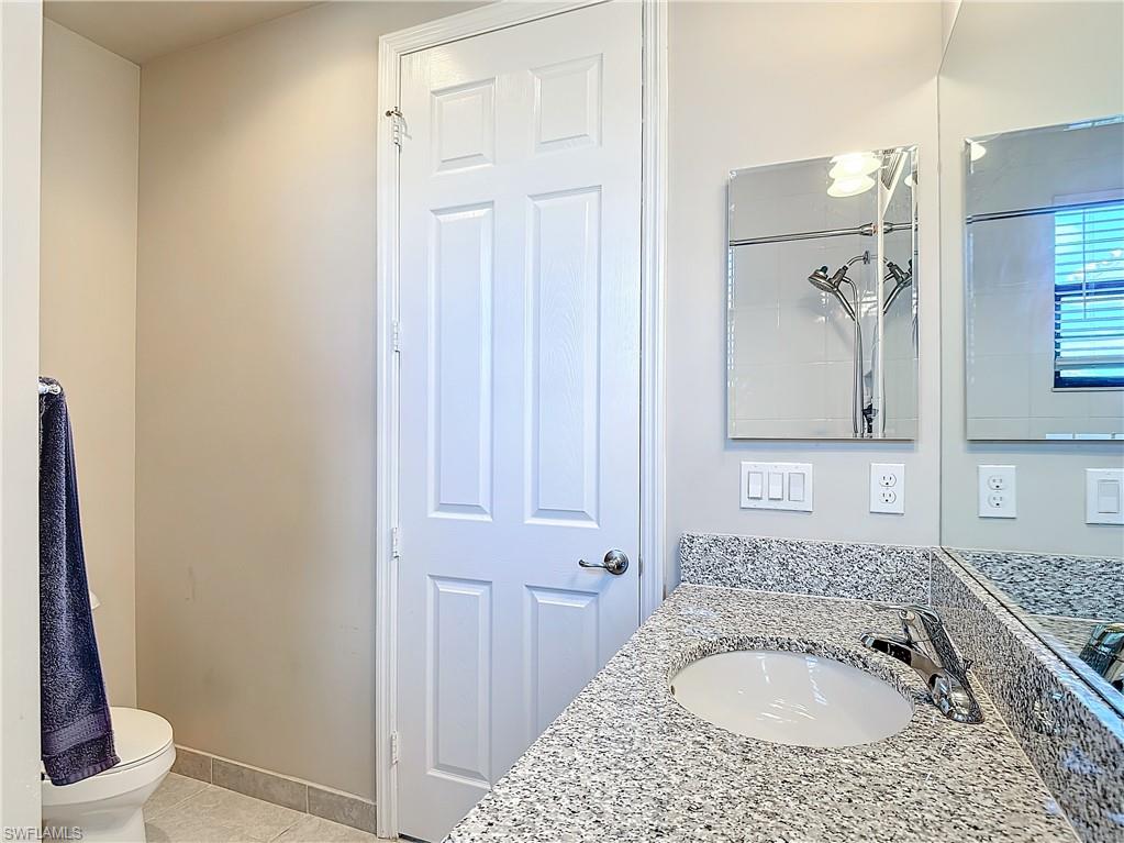 4310 Aurora Street Naples, FL 34119 - Photo 33 of 50 a bathroom with a sink and a toilet