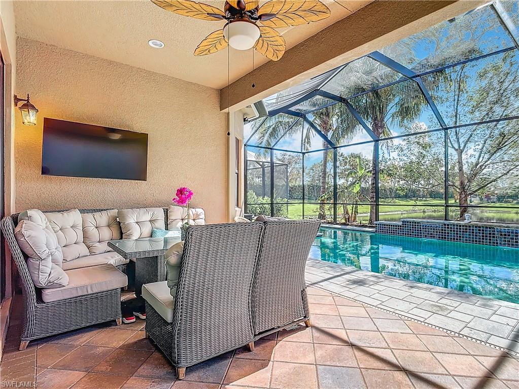 4310 Aurora Street Naples, FL 34119 - Photo 41 of 50 a outdoor space with patio the couches and a dining table with garden view