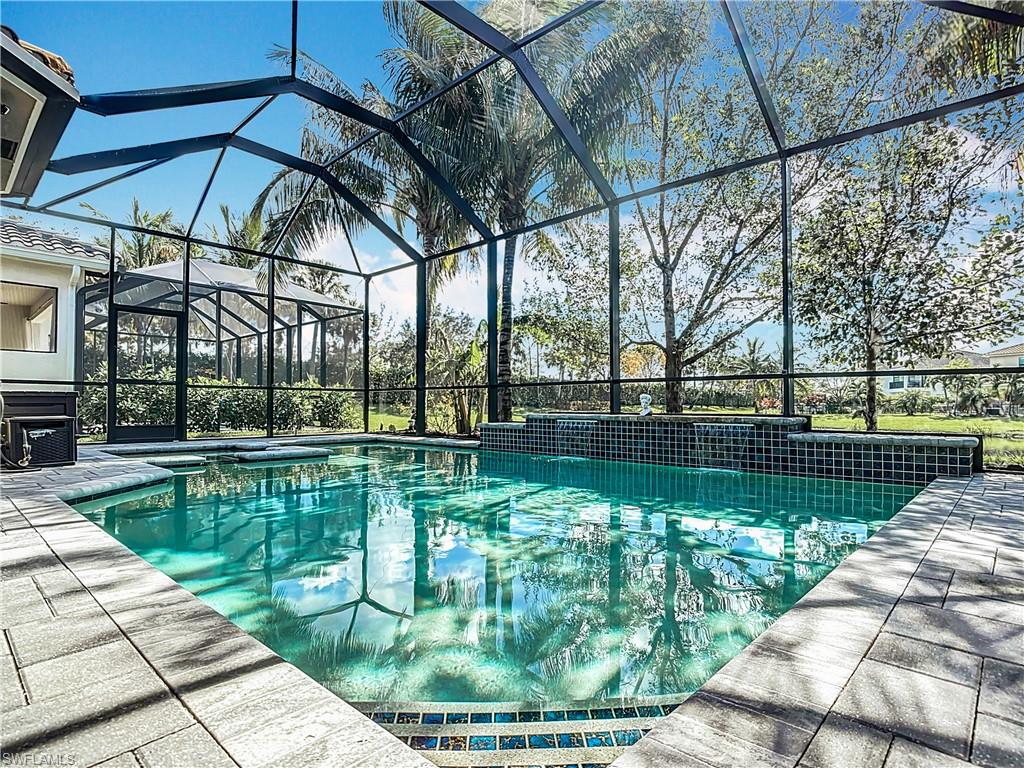 4310 Aurora Street Naples, FL 34119 - Photo 43 of 50 a view of a swimming pool with a patio