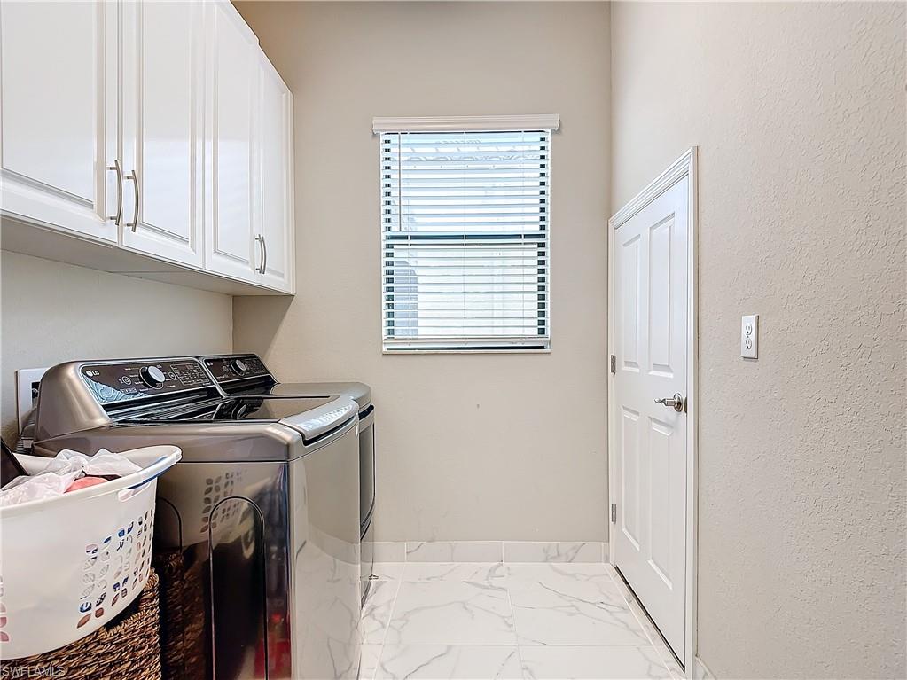 4310 Aurora Street Naples, FL 34119 - Photo 48 of 50 a utility room with dryer and washer