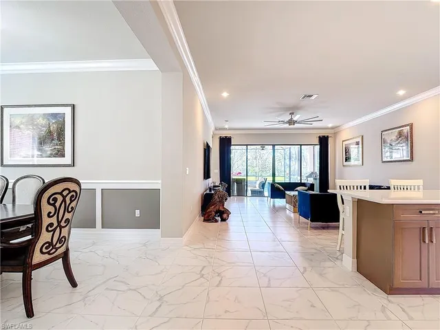 a living room with furniture and large windows