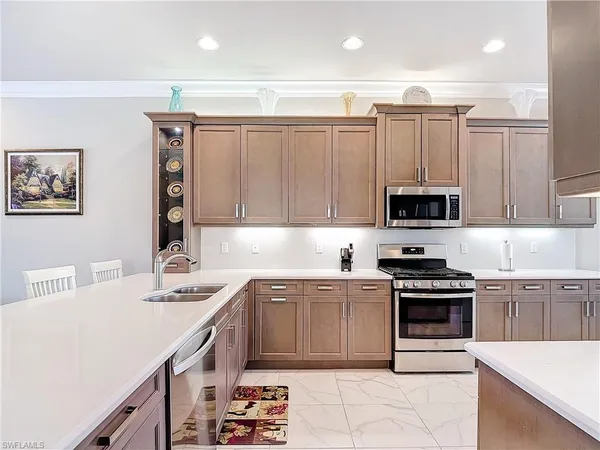 a kitchen with a sink stove top oven and cabinets