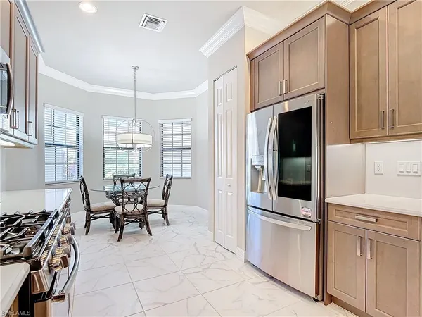 a kitchen with stainless steel appliances granite countertop a stove and a refrigerator