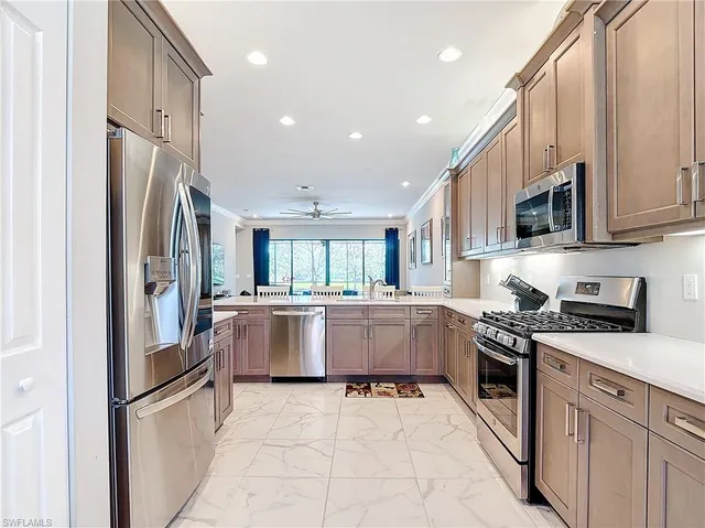 a kitchen with a refrigerator and a stove top oven
